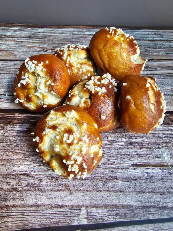 Salted sourdough pretzel bites on weathered planks